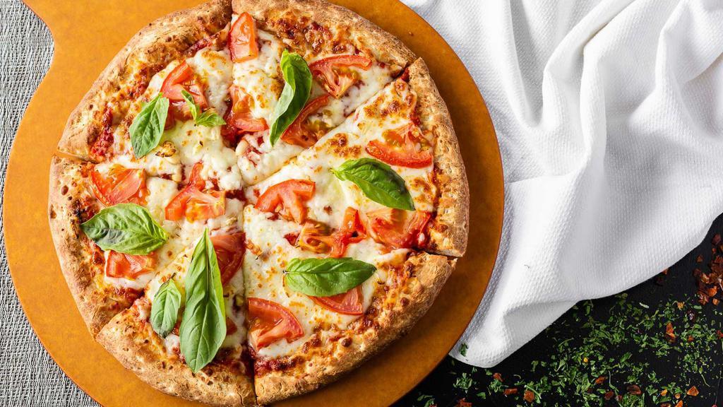 Margarita Pizza · Traditional hand tossed pizza. Homemade tomato sauce, mozzarella cheese, fresh tomatoes and fresh basil.