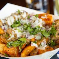 Puerco Verde Papas · Homemade seasoned fries topped with green chile pork and Oaxaca cheese.