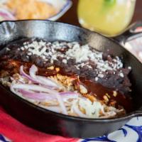 Carnitas Michoacanas Entrada · Slow-cooked pork marinated in Coca-Cola ™ and orange rind with red chile sauce, epazote blac...
