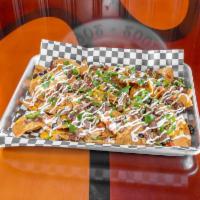 Sheet Pan Nachos · Fresh tortilla chips and our signature nacho cheese sauce topped with all the fixin's: roast...