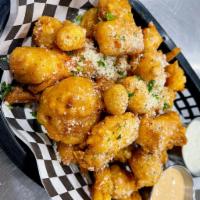 Beer Battered Cheese Curds · Wisconsin White Cheddar curds, hand-battered and made to order. Served with dipping sauces.