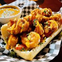 Shrimp Po' Boy · Crispy fried shrimp, lettuce, tomato, house tartar and roasted pepper aioli on a french roll.