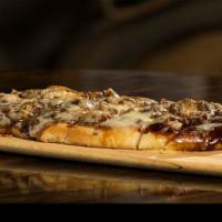 Pulled Pork Flatbread · Roasted pork butt, spicy BBQ sauce, grilled onions and white cheddar.