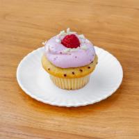 White Chocolate Raspberry Cupcake · Vanilla cake with raspberries baked in filled with a white chocolate mousse, topped with ras...