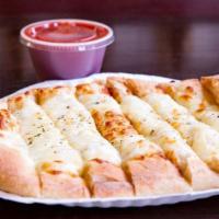 Cheesy Breadstix · Pizza dough topped with cheese and garlic seasoning with a side of pizza sauce.