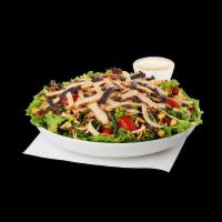 Spicy Southwest Salad · Slices of grilled spicy chicken breast served on a fresh bed of mixed greens, topped with gr...