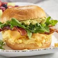 Bistro Breakfast Sandwich · Cage free scrambled eggs, apple-wood smoked bacon, cheddar, arugula, avocado mash on a brioc...