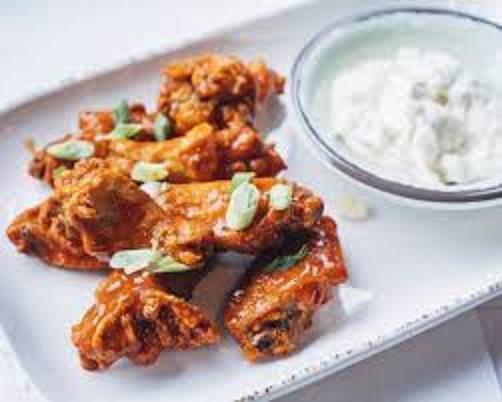 Classic Chicken Wings · Eight bone-in wings, choice of bleu cheese, ranch or green goddess dressing.