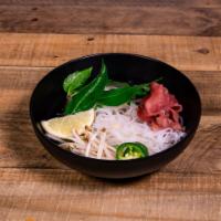 P1. Pho Tai · Beef medium rare, noodle soup. Served with a basket of fresh herbs, crispy bean sprouts, lim...