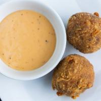 Boudin Bites · Rice, pork, ＆ a blend of Cajun seasonings, rolled ＆ battered to perfection!