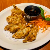 Pot Sticker · Crispy pot sticker wrapped filled with pork, cabbage, ginger served with house Thai style gi...