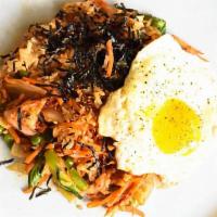 Kimchi Fried Rice · Panfried Kimchi with rice and bacon, seaweed and egg on top. Mild or spicy.