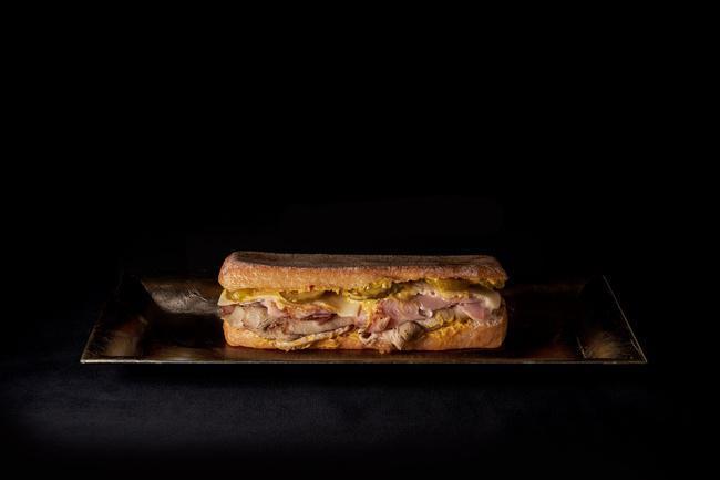 Cubano Italiano - · Roasted Pork, Smoked Ham, Swiss, Pickles, house made Mustard