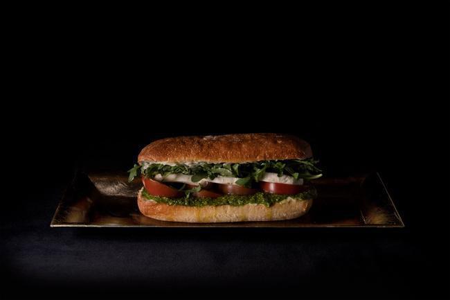 Caprese Sandwich - · Tomato, Mozzarella, Basil Pesto, Arugula. Comes with Kettle Chips.