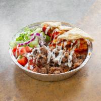 Lamb over rice · Lamb over rice and salad with special white sauce.pite bread