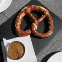 Soft Pretzel · Large Oven Baked Soft Pretzel Sprinkled with Sea Salt. Served with Sweet Bavarian Mustard an...