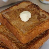 French Toast · 3 slices of grilled French toast. Served with real butter and 100% natural syrup.