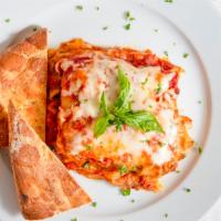Lasagna · Layers of pasta, ground beef, bechamel and mozzarella cheese with tomato sauce.