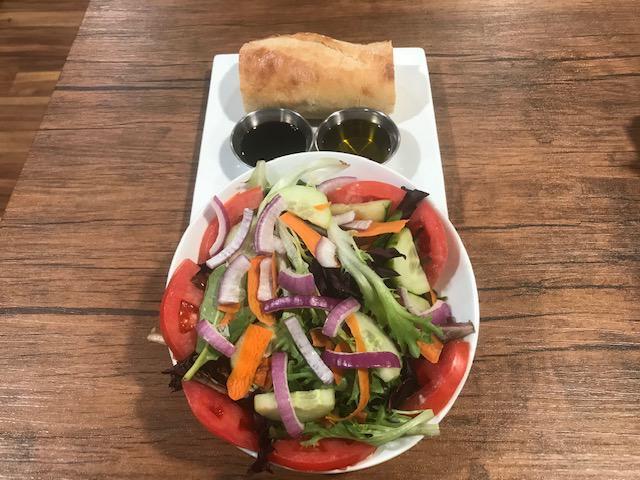 Tossed Salad · Mixed greens, tomatoes, red onions, sliced carrots, cucumbers, radish.