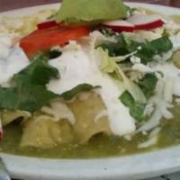 33. Enchiladas Suizas · Served with chicken and green sauce, melted cheese and sour cream.