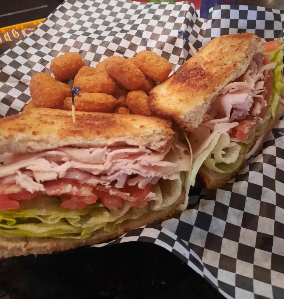 Smoked Turkey and Bacon Sandwich · Wheat berry bread, smoked turkey, bacon, cheddar cheese, lettuce, tomato, onions, pickle and mayo.