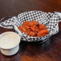 Boneless Chicken Wings · Cooked wing of a chicken coated in sauce or seasoning.