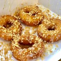 Thai Donut · 5 pieces. Fried donuts coated with condensed milk sprinkled with crushed peanuts.