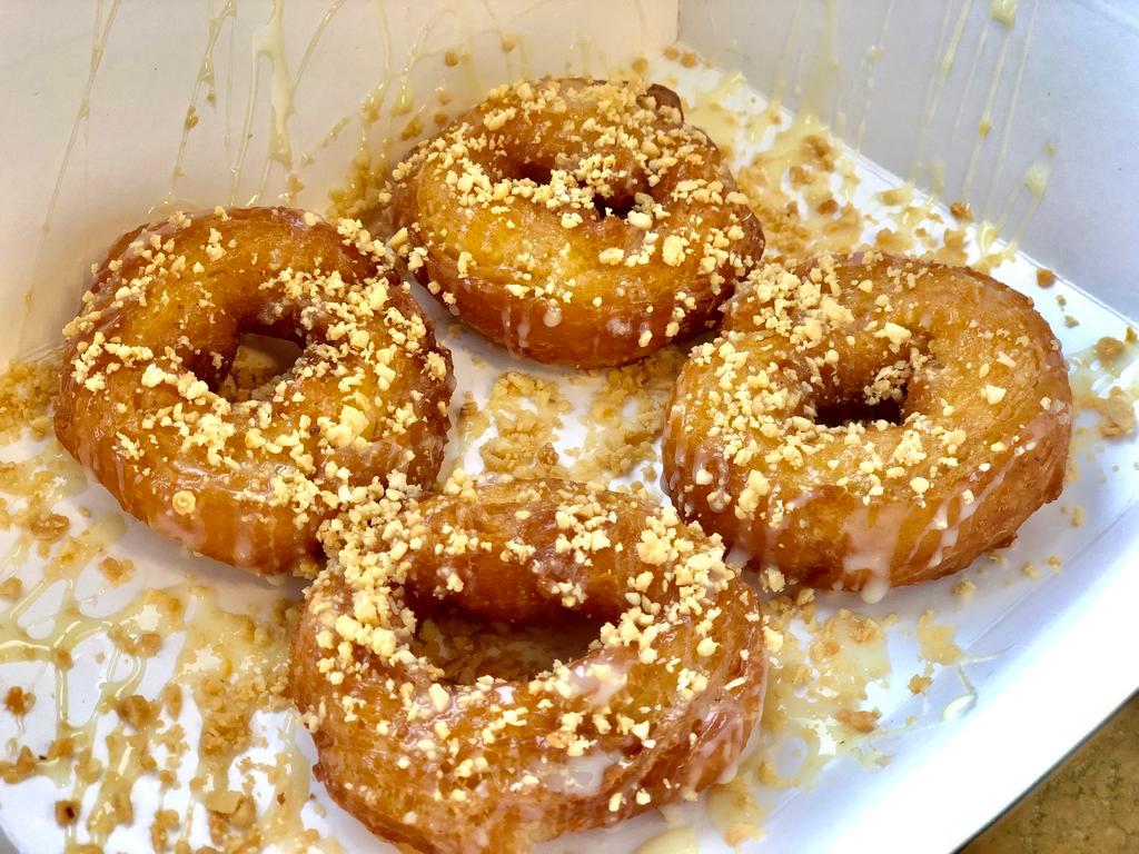 Thai Donut · 5 pieces. Fried donuts coated with condensed milk sprinkled with crushed peanuts.