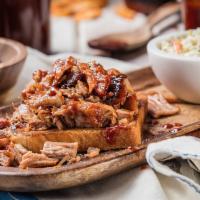Georgia Chopped Pork · Smoked for up to 12 hours and chopped to order.Served with choice of 2 sides and a  Corn Bre...