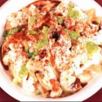 Papdi Chaat · Indian style nacho topped with yogurt, potatoes, chickpea, spices with mint and red chutney....