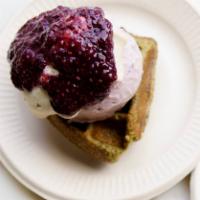 Matcha Berry Waffles · Matcha waffle topped with strawberry ice cream covered in coconut whip with a lump of chia b...