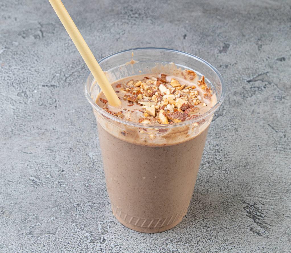 Nutty Me Smoothie · Banana, almond butter, cocoa powder, almond milk, maca powder, dates. Topped with toasted almonds.