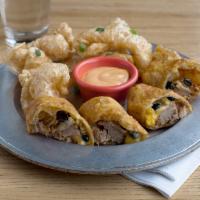 Carolina Rolls · Pulled pork, black corn relish, shredded cheese, rolled and deep
fried in a flour tortilla.