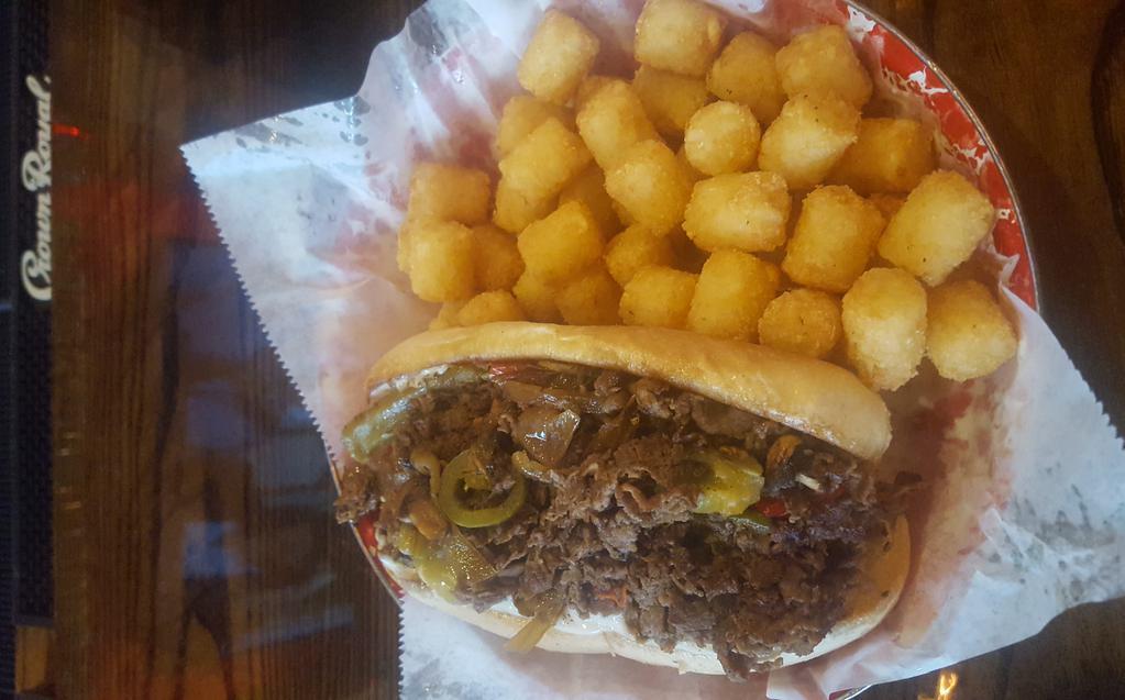 Philly Cheese Steak · Seasoned sliced ribeye steak or sliced grilled chicken, green and red peppers, caramelized onions, jalapenos, grilled mushrooms, provolone, toasted hoagie roll. Served with choice of side.