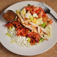 Cobb Salad · Crisp lettuce, chicken breast, crumbled blue cheese, tomatoes, bacon and a hard-boiled egg.