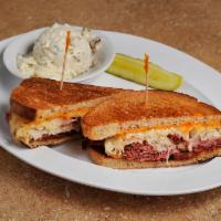 Our Famous Grilled Reuben Sandwich · Corned beef and pastrami steamed and piled high with sauerkraut, Swiss cheese and Russian dr...