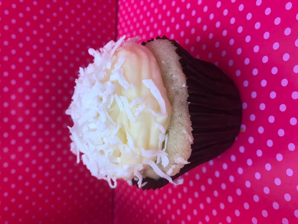 Coconut Cupcake · Vanilla cake with a coconut cream cheese frosting and shredded coconut 