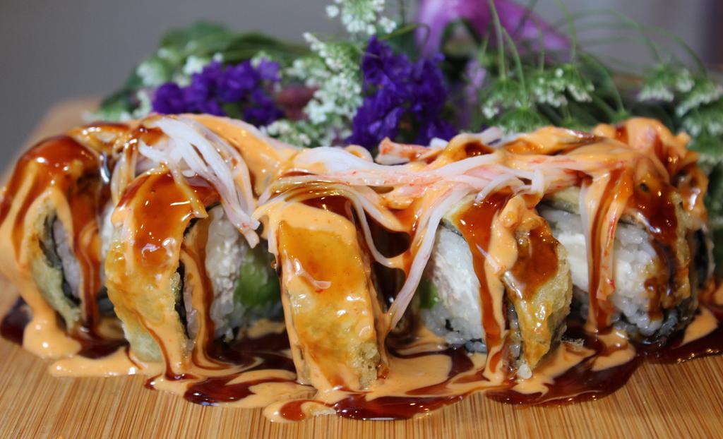 Scarlet Roll · (Tempura Roll & Cooked) Spicy Tuna, avocado, and cream cheese topped with crab meat, spicy mayo, and brown sauce on top.