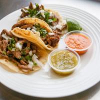 Tacos · Soft tortilla, choice of meat, cilantro and onion.