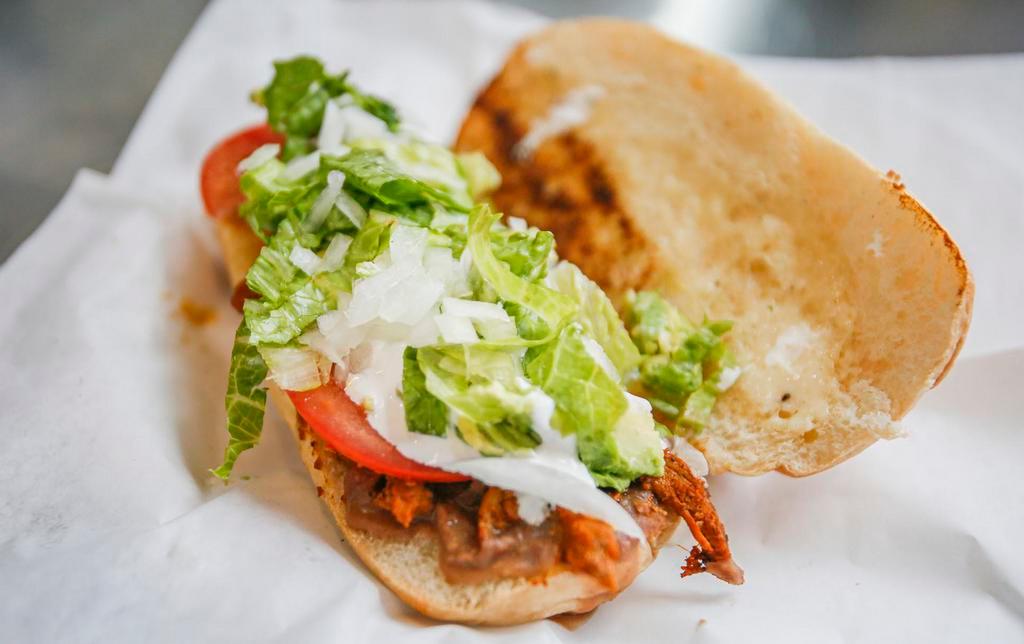 Torta · Soft style bread, choice of meat, beans, onion, tomato and jalapenos.