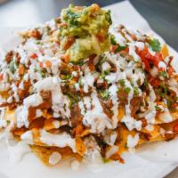 Nachos · Tortilla chips, choice of protein, beans, cheese, guacamole and jalapenos.