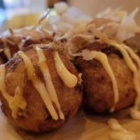Takoyaki · 6 pieces. Stuffed wheat cake with octopus, served with spicy mayo and teriyaki sauce, topped...