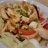Jumping Squid Salad · Fresh squid mixed with Thai herbs, red onion, scallion, cilantro, tomato, cucumber and lime ...