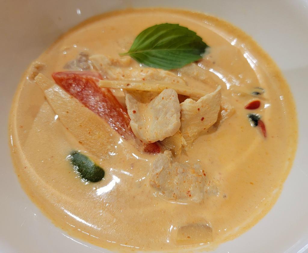 Red Curry · Thai red curry pasted in coconut milk with bamboo shoot, bell pepper and fresh basil. Spicy.