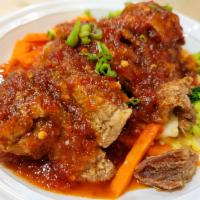 Volcano Duck · Crispy duck topped with volcano sauce on top of fresh mixed vegetables. Spicy.