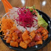 Spicy Poke Don · Spicy tuna or salmon on top of sushi rice with avocado, red onion, seaweed salad, carrot, da...