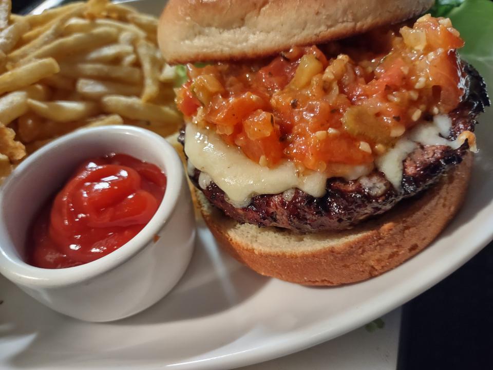 Burger · aged white cheddar, artisan lettuce,
 tomato jam, white truffle butter,
 brioche bun, house fries