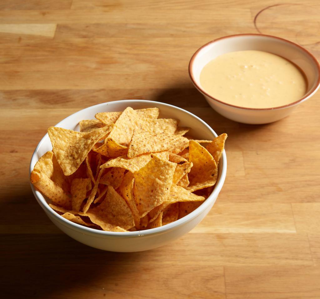 Mexican Village Queso Dip · Mexican cheese fondue, a combination of melted cheese, diced green chile and peppers, served with crisp corn tortilla chips. Add extras for an additional charge.