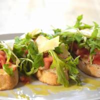 Bruschetta · Toasted homemade bread, diced tomatoes and basil, arugula and parmesan flakes.