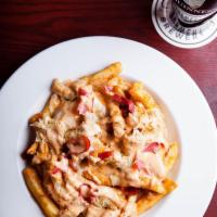 Irish Poutine · Fries, shredded corn beef, Swiss, and sauerkraut. Comes with your choice of gravy or Thousan...